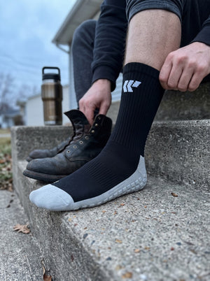 Putting on work boots over Trades socks